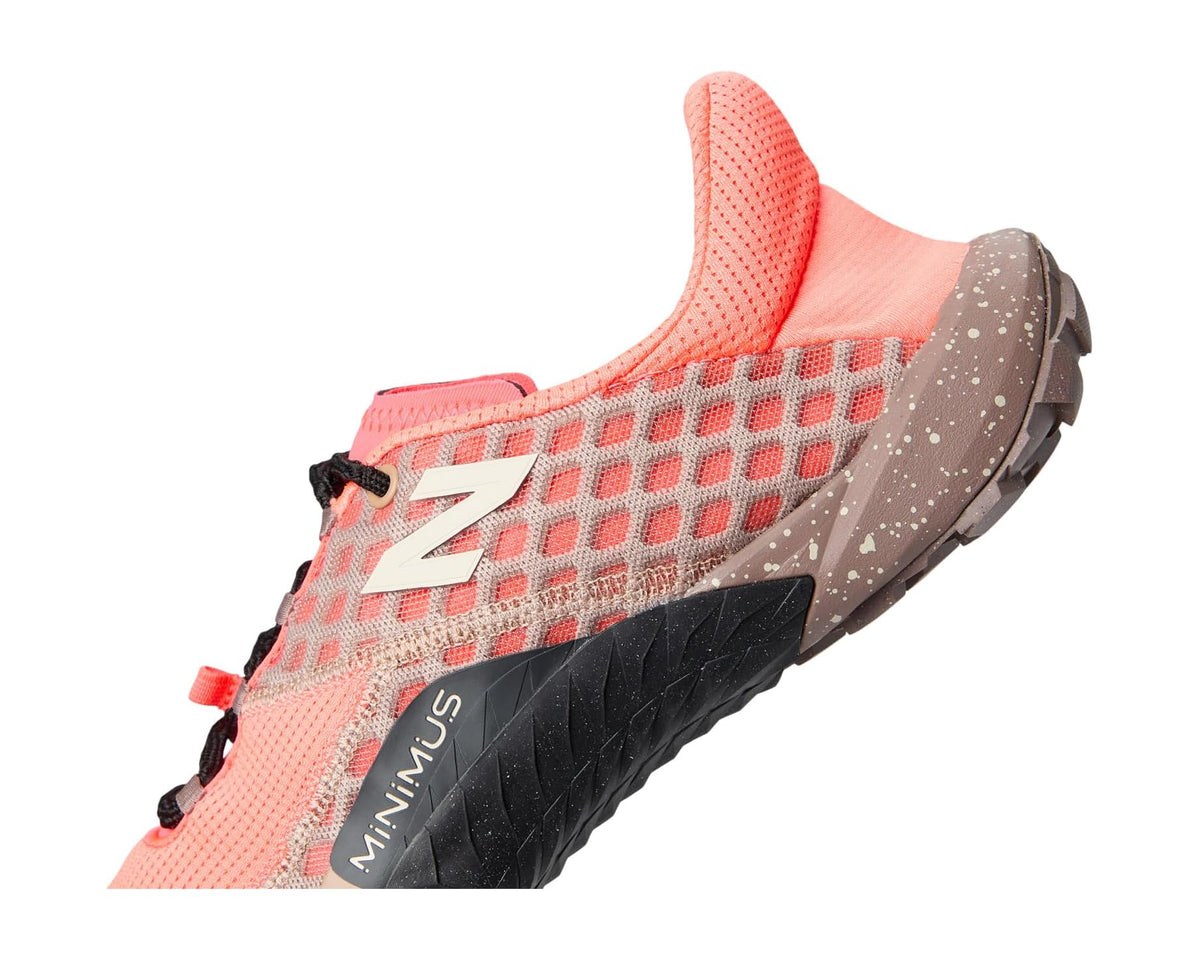New Balance Minimus trail shoe side close-up, coral knit upper with black MINIMUS panel