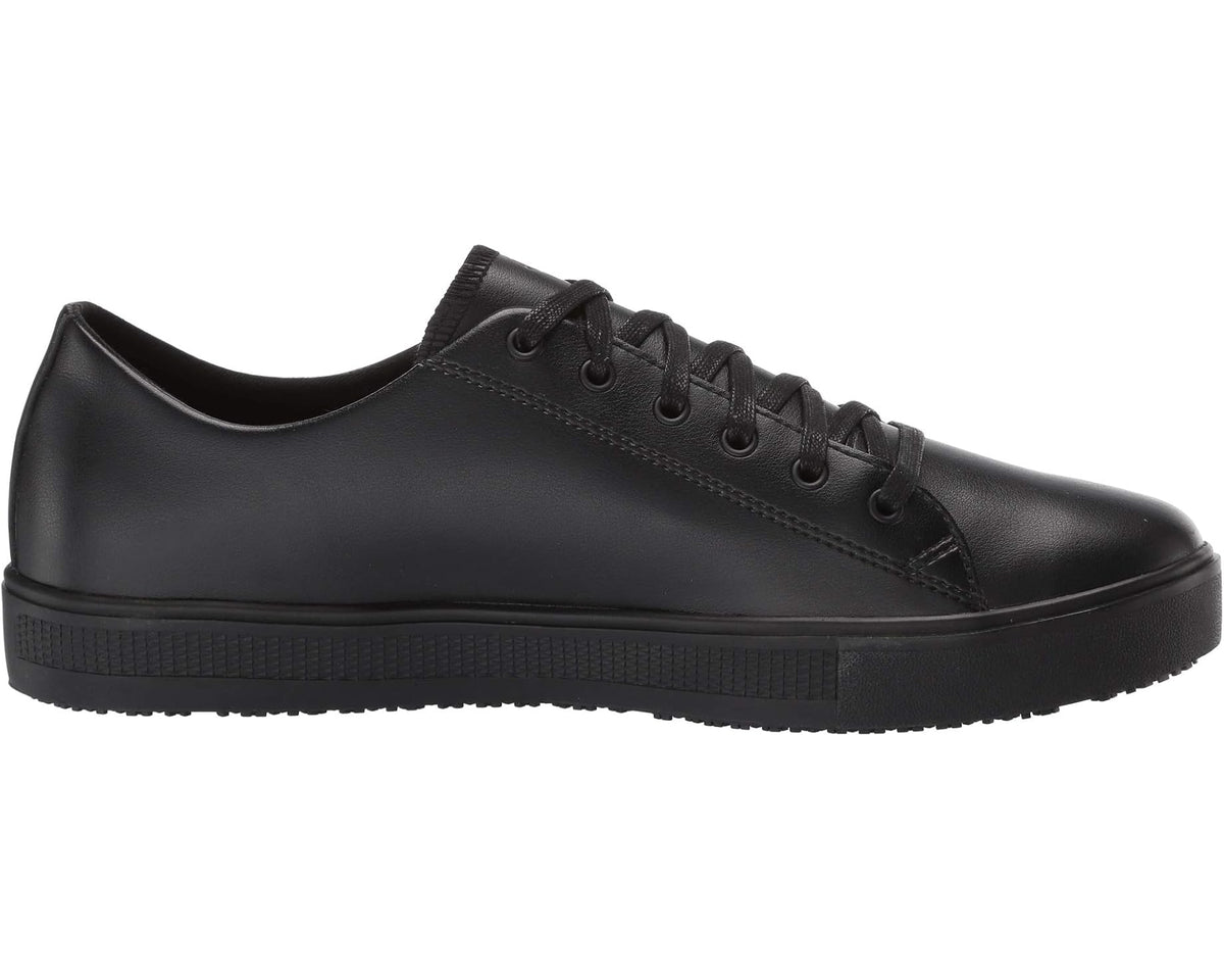 Black lace-up low-top shoe side view with stitched panels and rubber sole