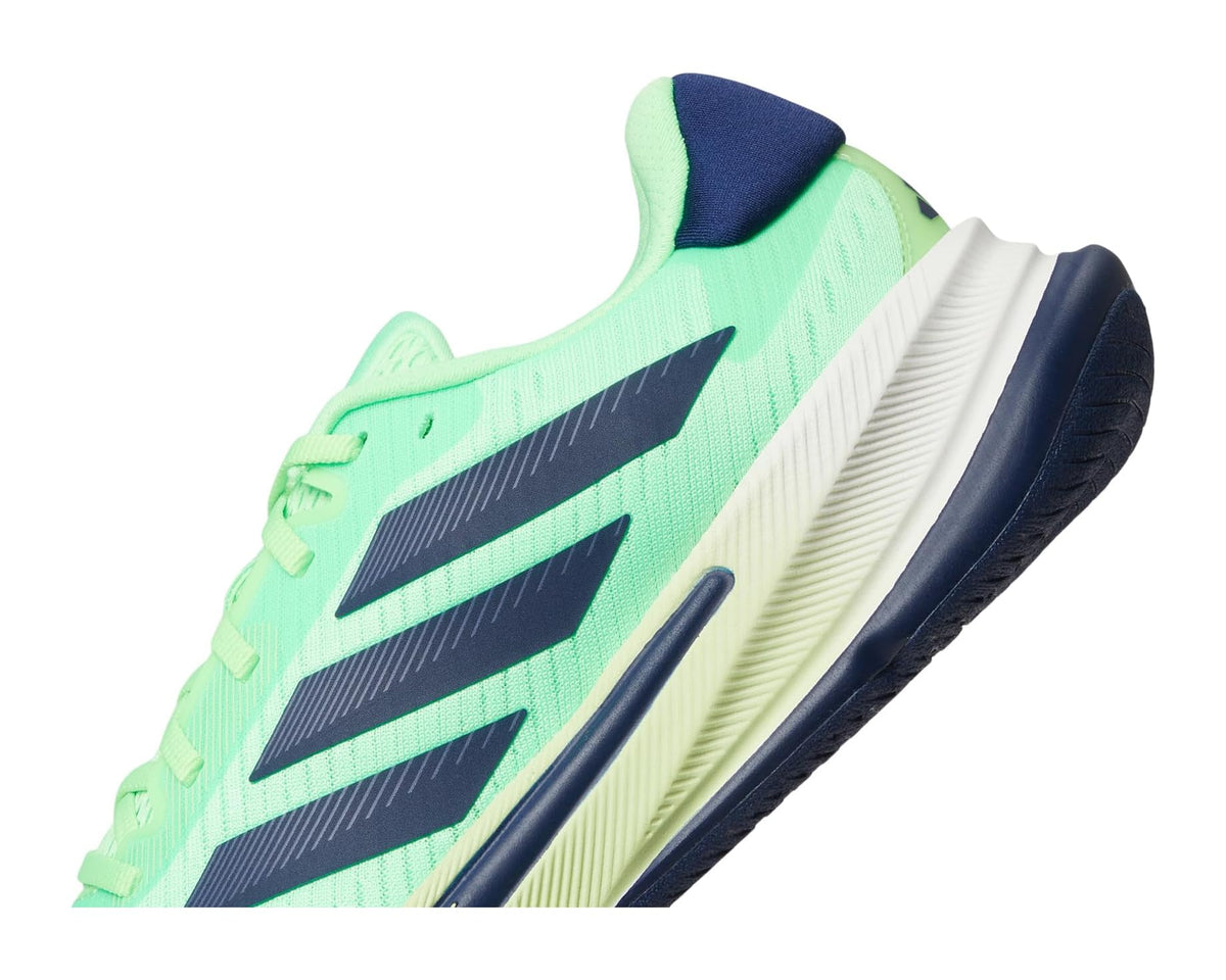 Close-up of lime green upper with three black stripes and navy sole edge