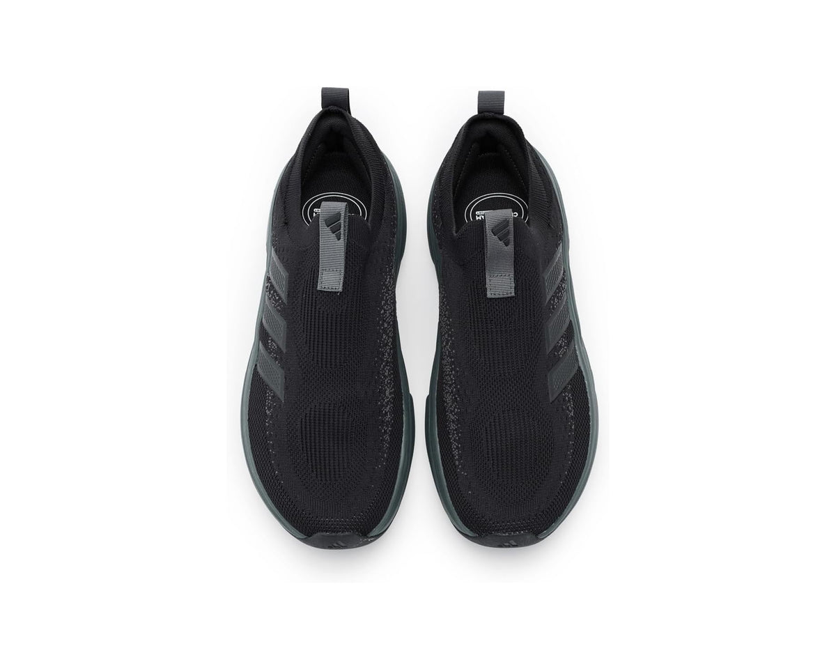 Pair of black knit slip-on sock shoes with grey tag and teal-trimmed sole
