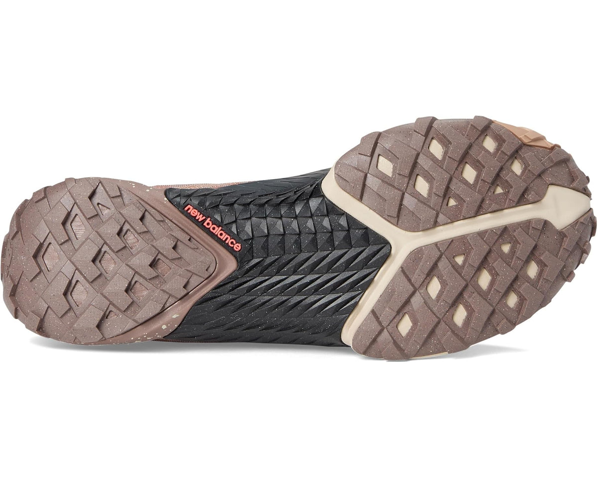 New Balance Minimus trail shoe outsole view, dark traction tread with taupe heel panel