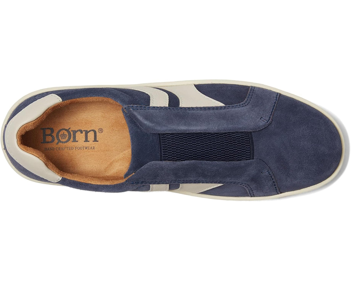 Navy suede slip-on sneaker interior with tan lining and white accents