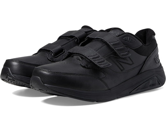 Men's New Balance sneaker, black leather upper with strap and lace closure