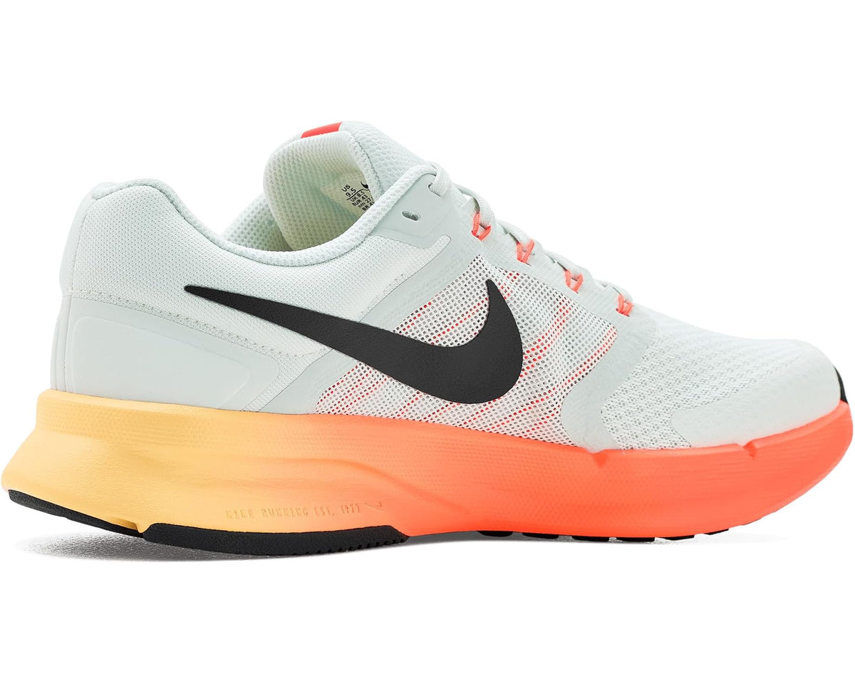 Men's Nike running shoes, light gray knit upper with black swoosh and orange sole.
