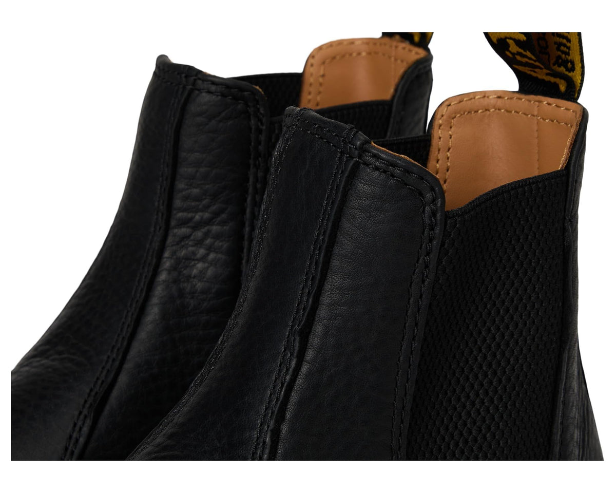Unisex black leather Chelsea boot close-up of elastic gore and stitched upper seams