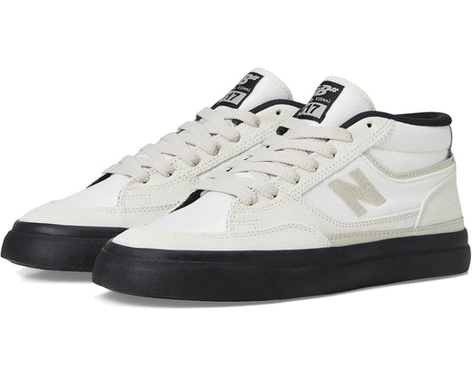 White and black low-top skate shoes with lace-up closure and padded collar