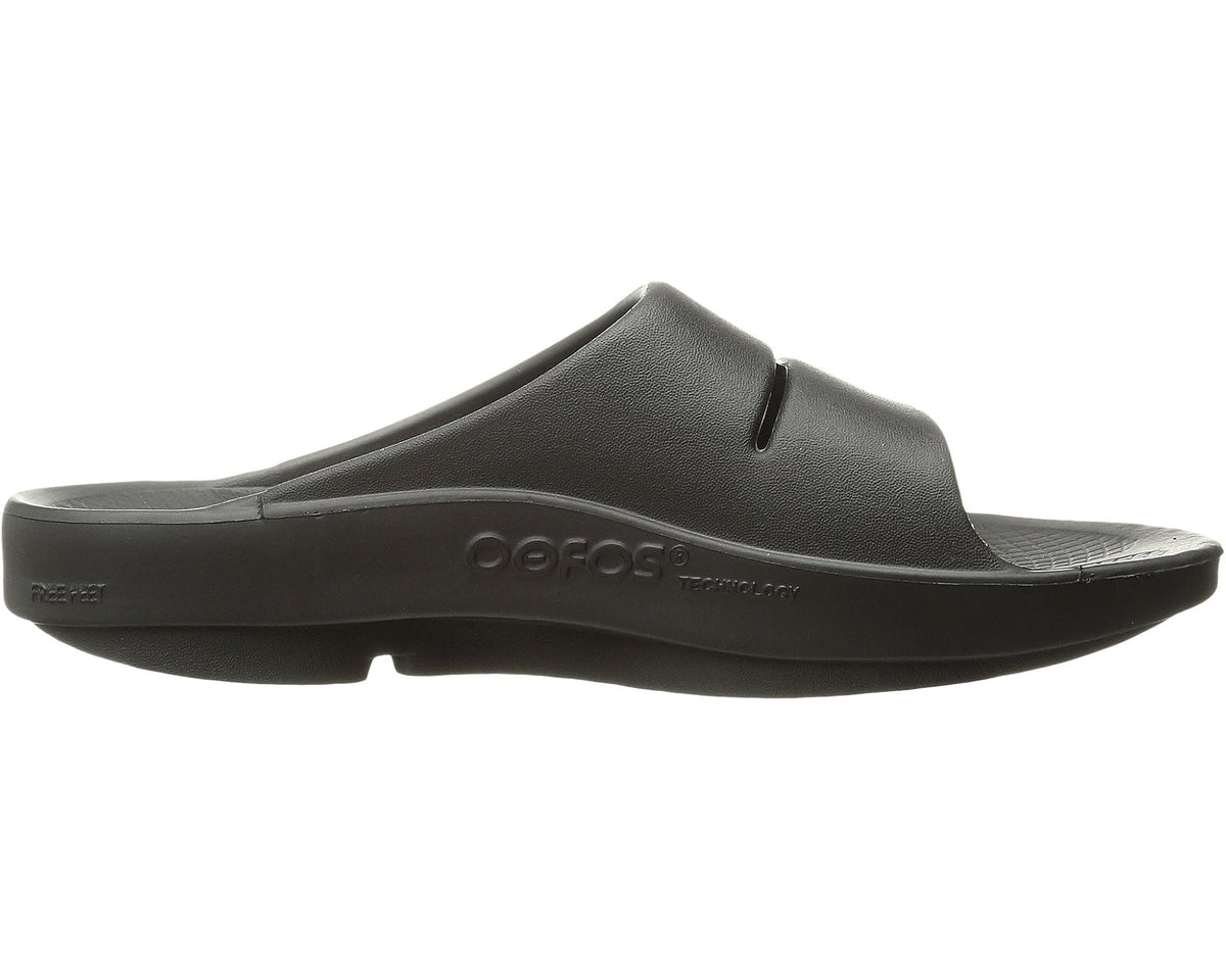 Black slip-on slide sandal side profile with strap cutout and molded sole