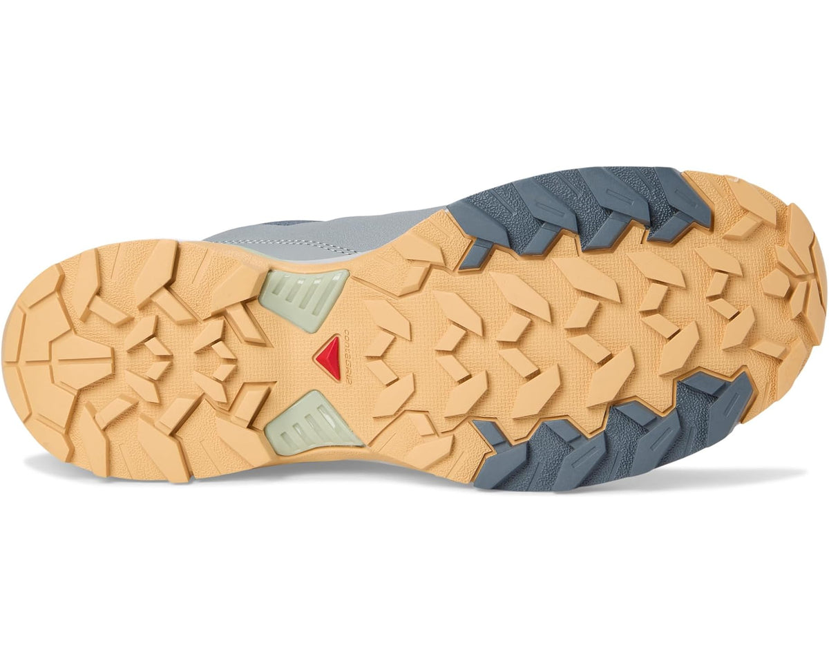Men's trail shoe outsole with rugged tan tread, blue and red traction markings