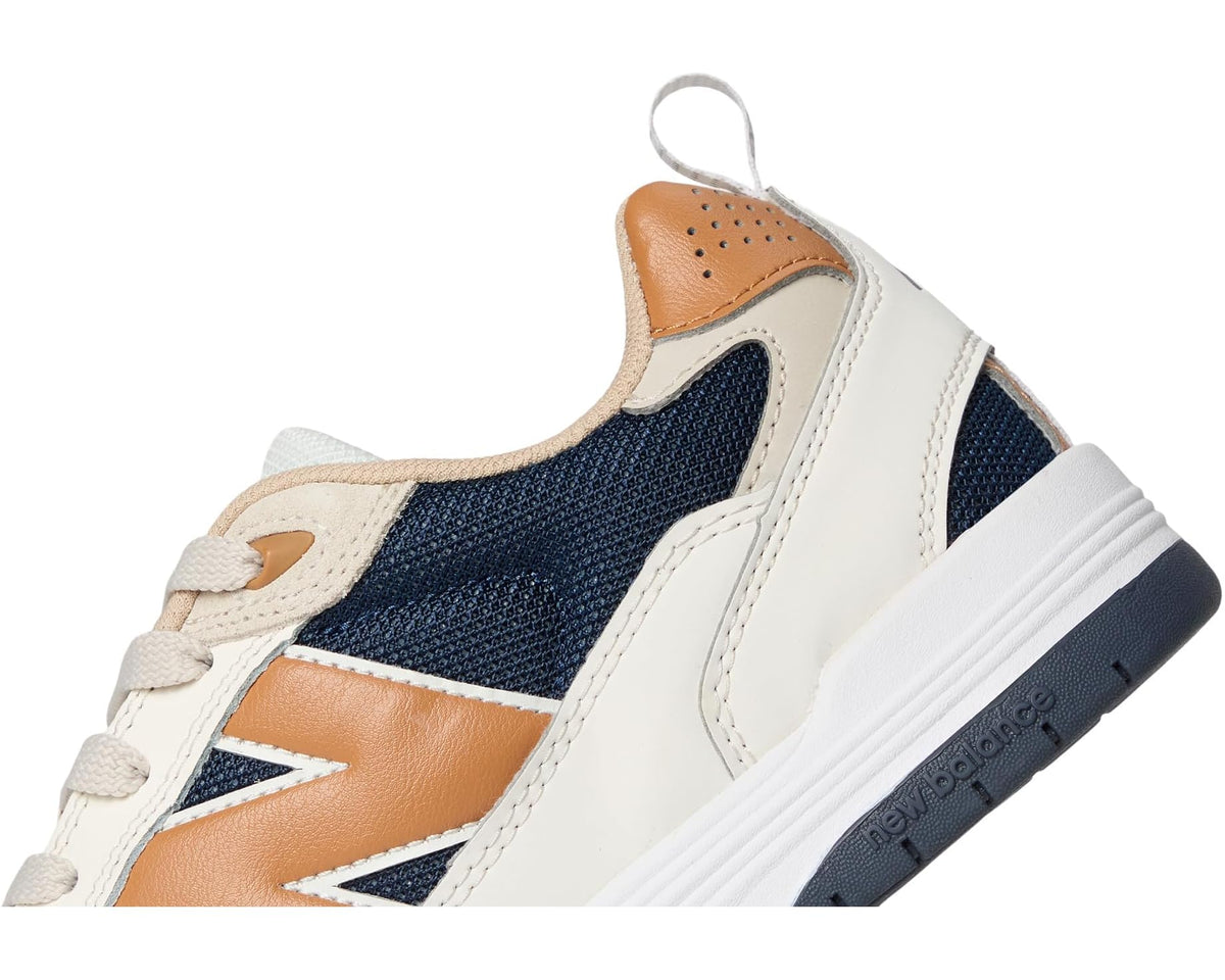 New Balance sneakers quarter view, tan heel tab and navy mesh side panel