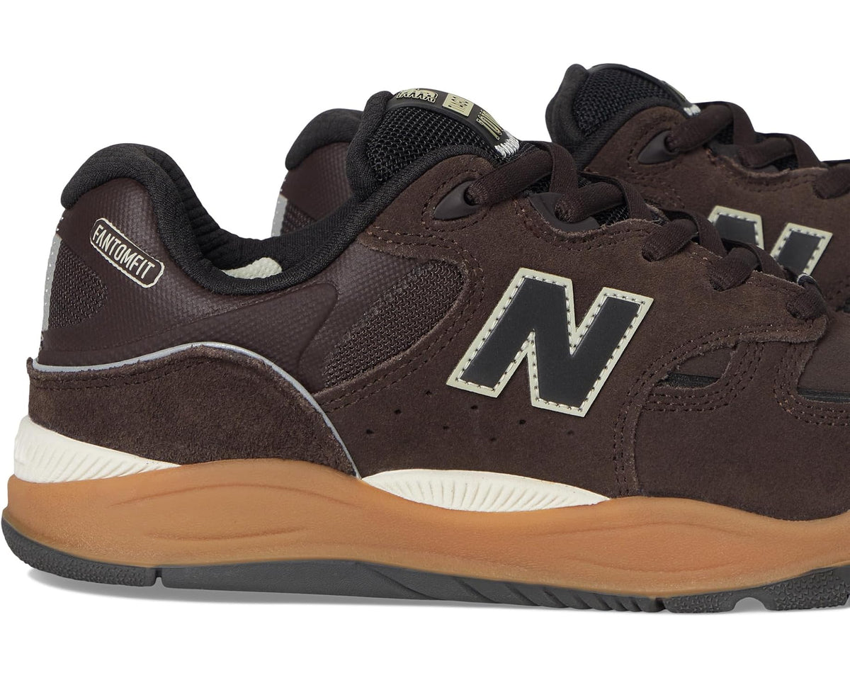 Brown New Balance 1010 side view, lace-up suede upper with large N logo and tan sole.