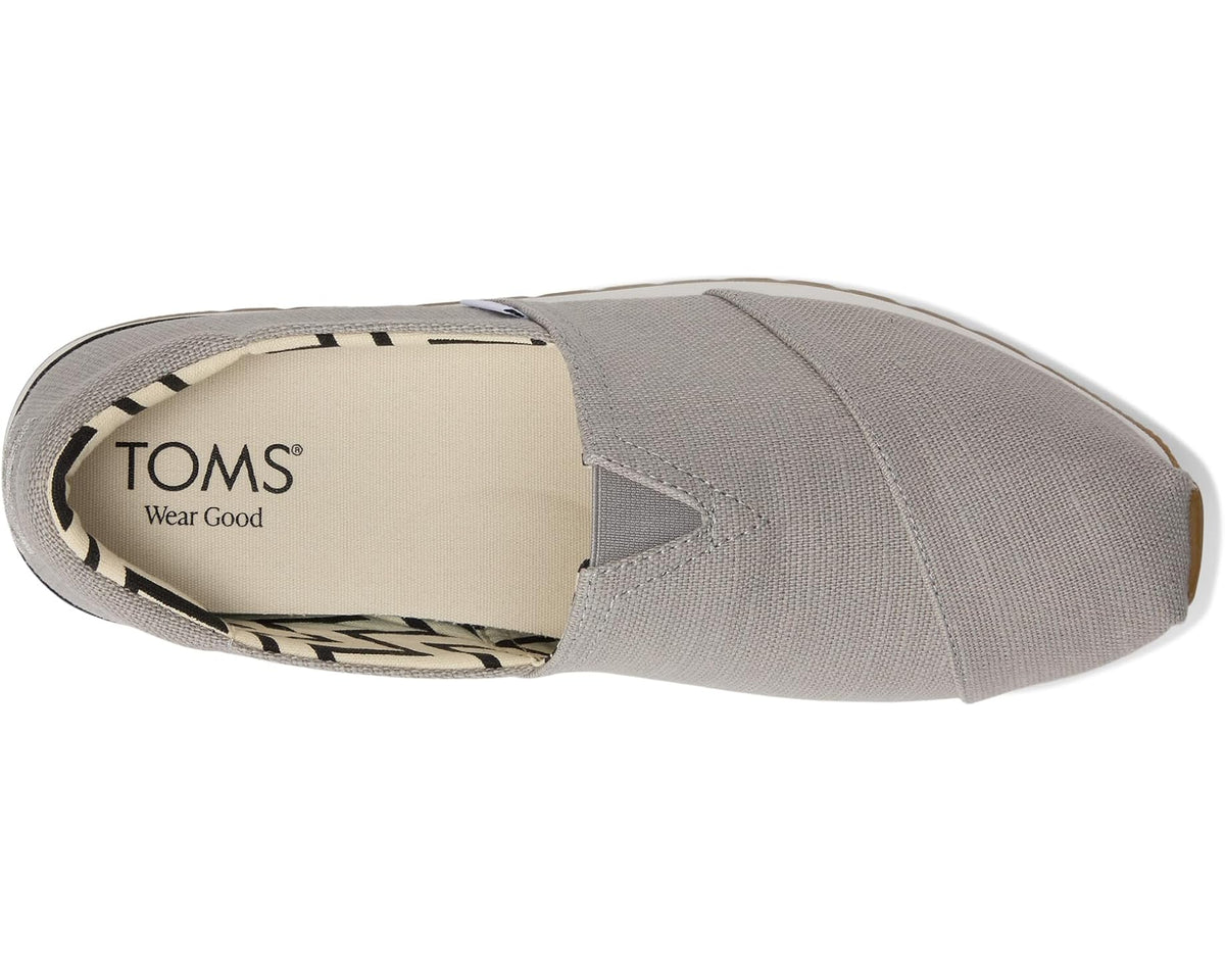 Men's TOMS slip-on shoes, grey fabric upper with TOMS logo on the heel lining.