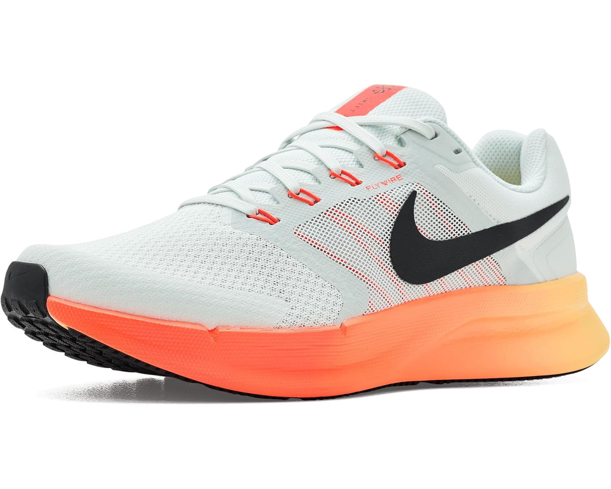 Men's Nike running shoes in light gray with black swoosh and orange outsole.