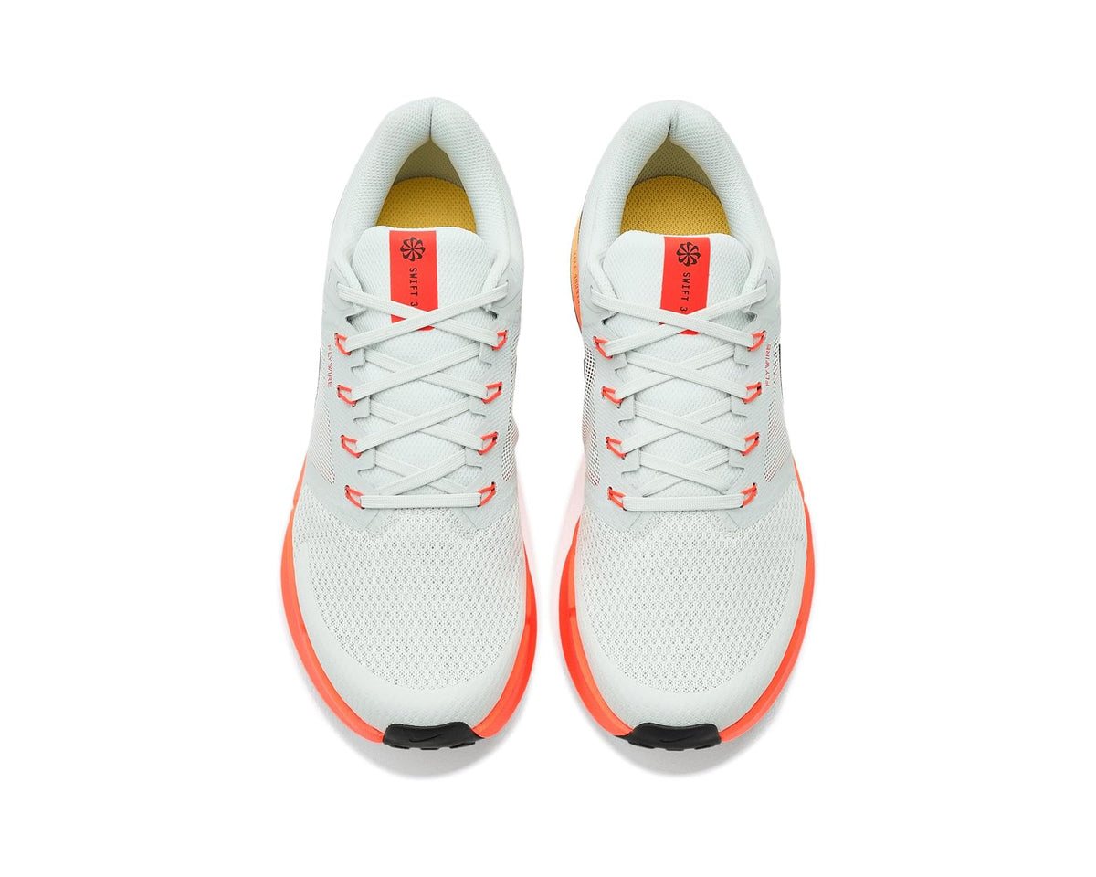 Men's Nike running shoes pair with white laces, light gray uppers, orange accents.