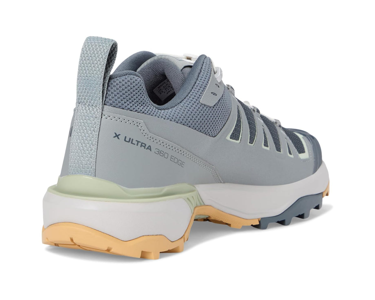 Men's heel and collar view of blue-gray trail shoe with light green trim and tan outsole