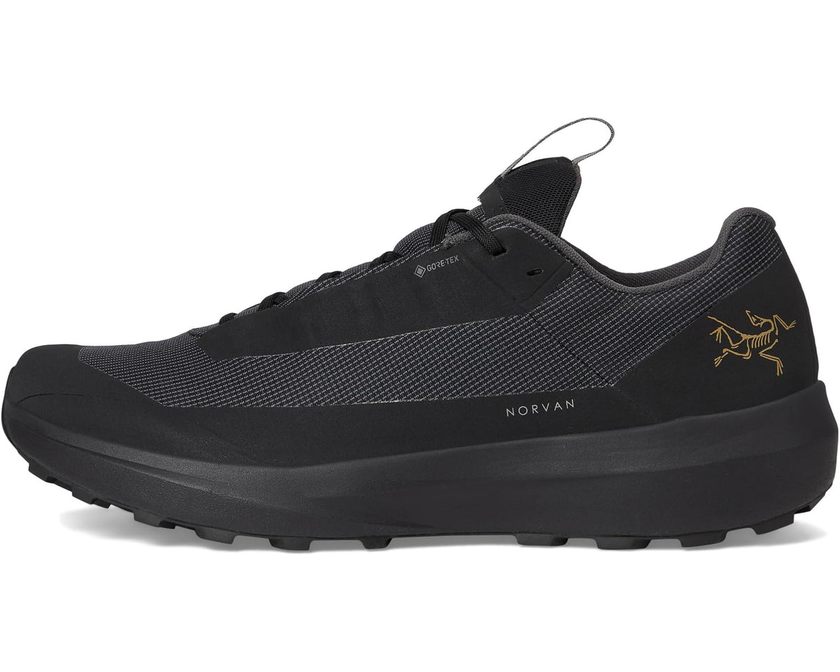 Unisex black low-top trail shoe with lace-up front and side logo detail