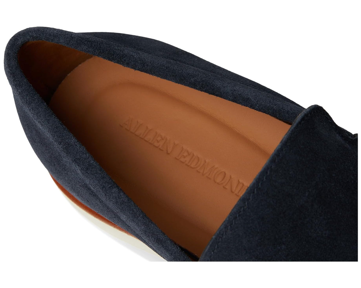 Men's navy suede loafer interior view with tan lining and embossed brand on insole