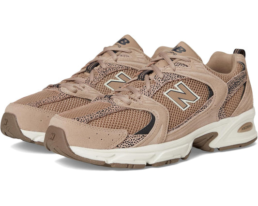 New Balance 530 unisex sneakers in taupe with black accents and white sole, lace-up.