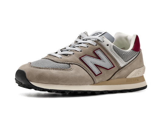 Beige and gray lace-up sneakers with maroon N logo, mesh panels, and padded collar