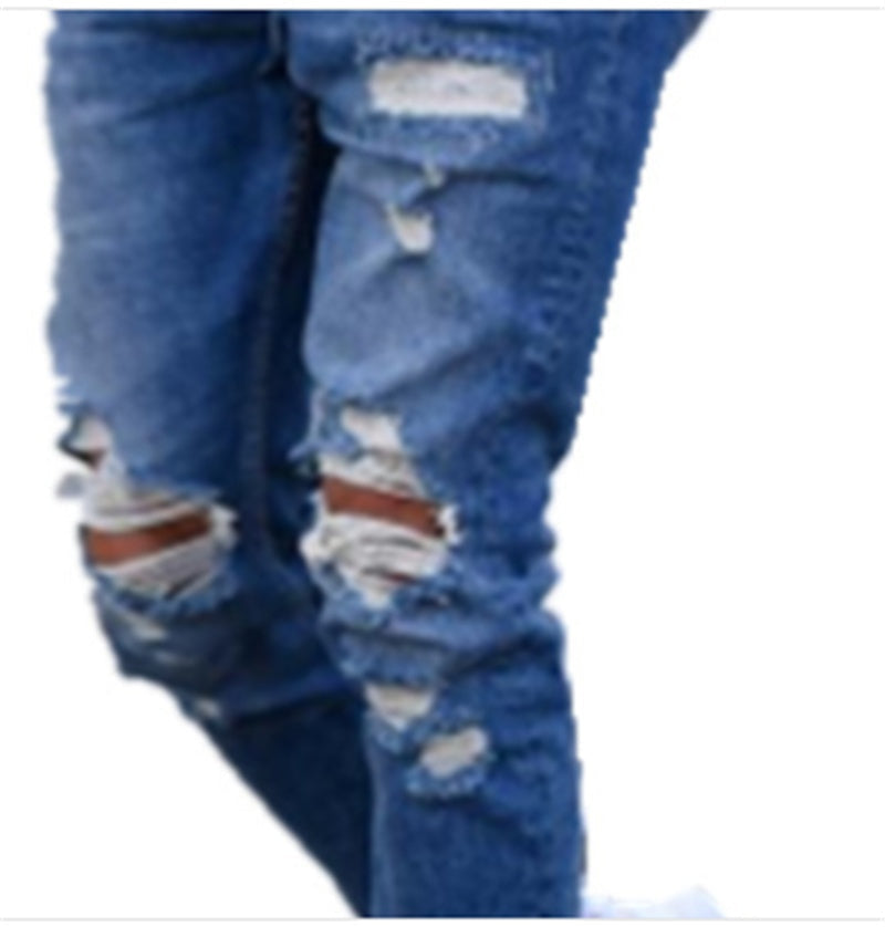 Deep blue denim jeans close-up with multiple rips, frayed edges, faded patches