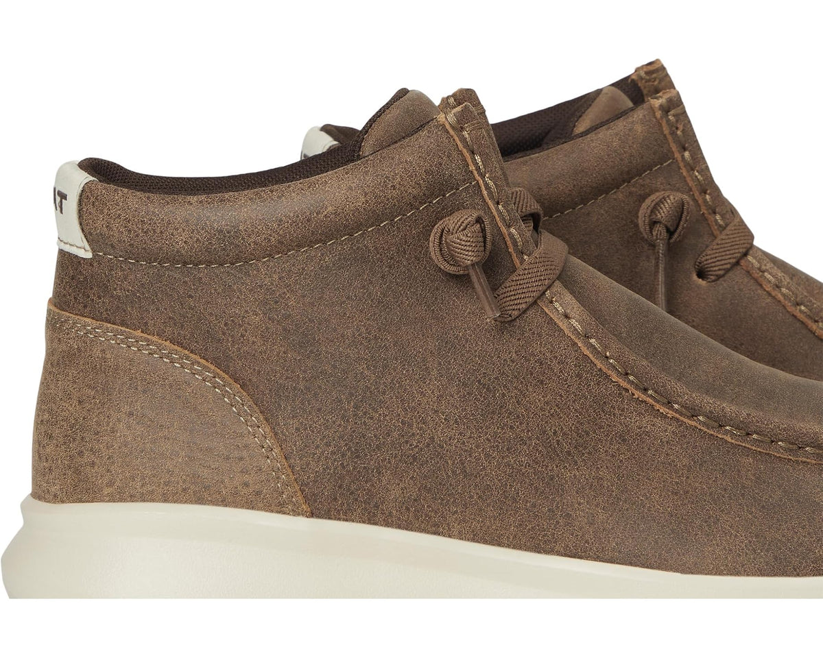 Brown suede chukka boot side profile with lace-up eyelets and white midsole
