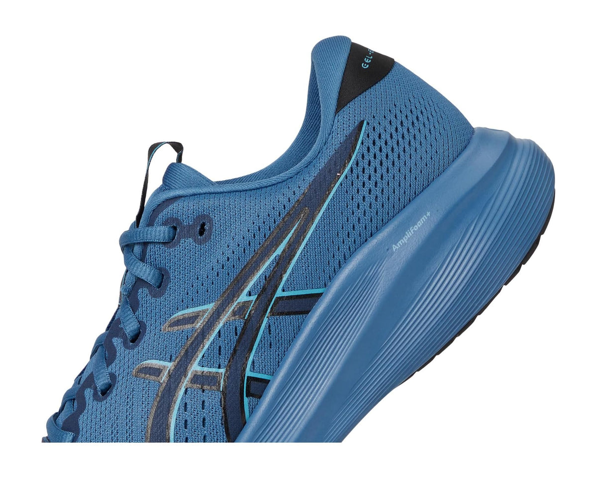 Men's blue running shoe close-up of side panel, laces, and cushioned collar