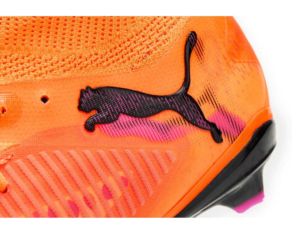 PUMA men's soccer cleat close-up, orange textured upper with black PUMA logo