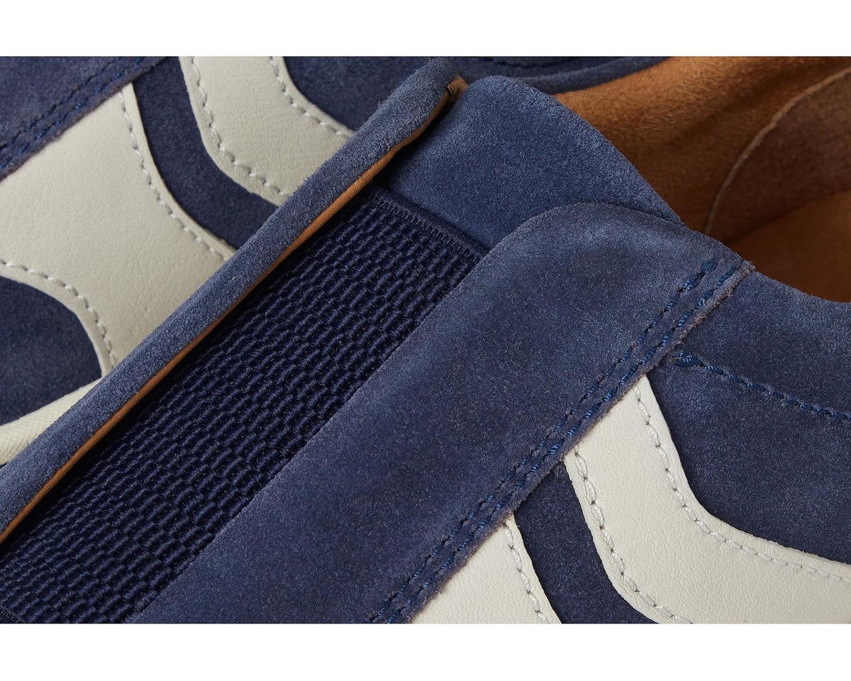 Close-up of navy suede slip-on with elastic side insert and stitching