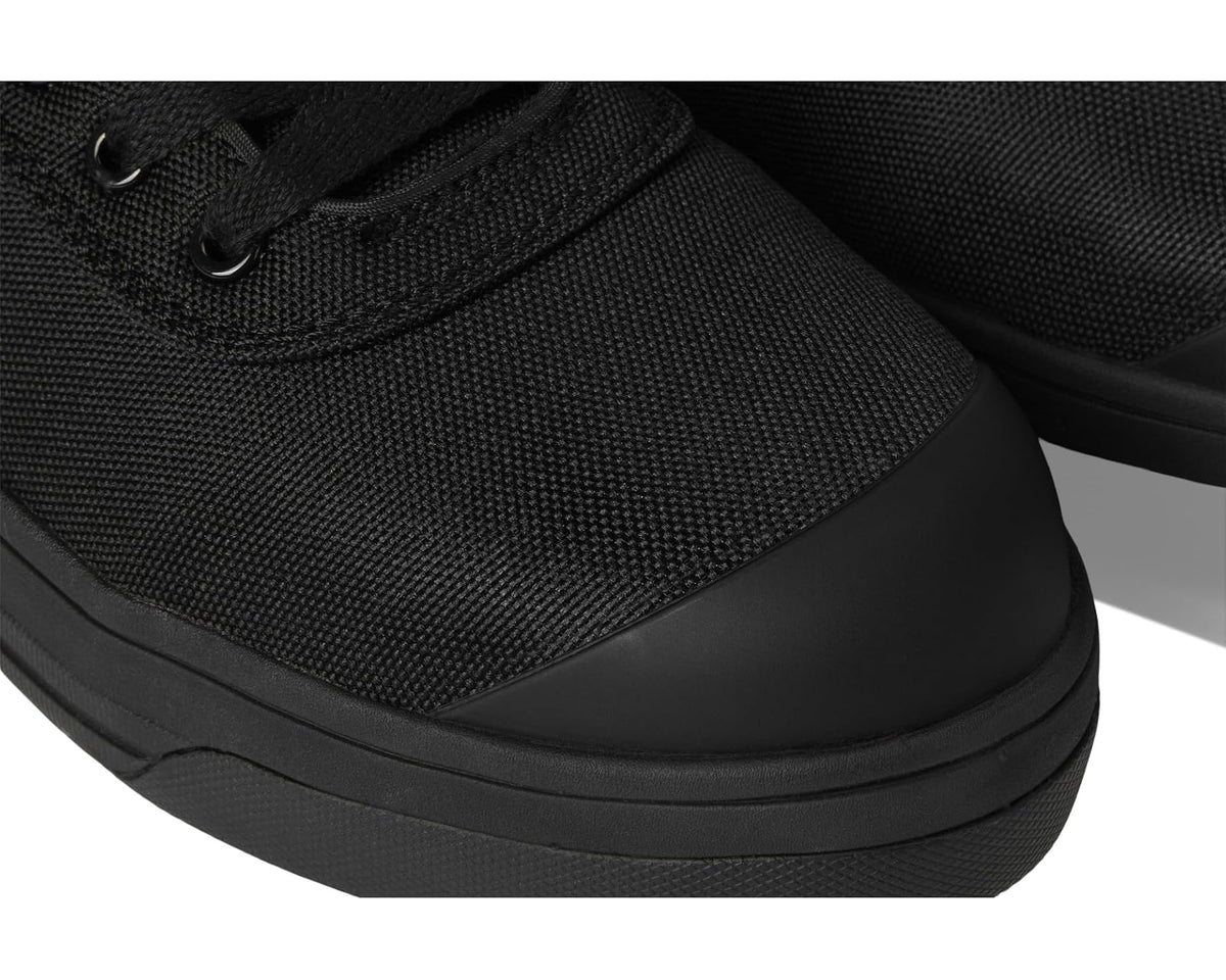 Close-up of black woven upper and rubber toe bumper