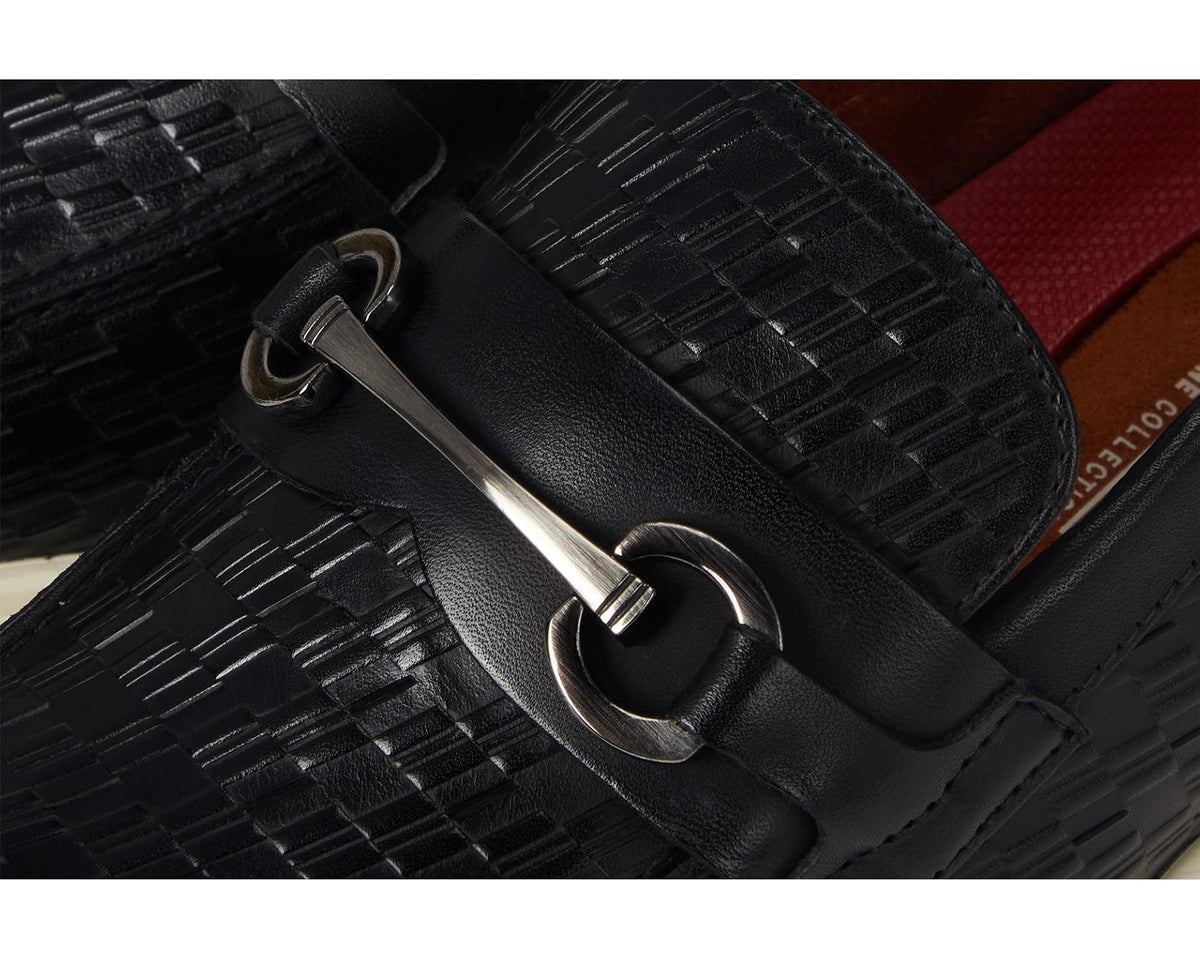 Close-up of black moc toe slip-on buckle strap on woven leather