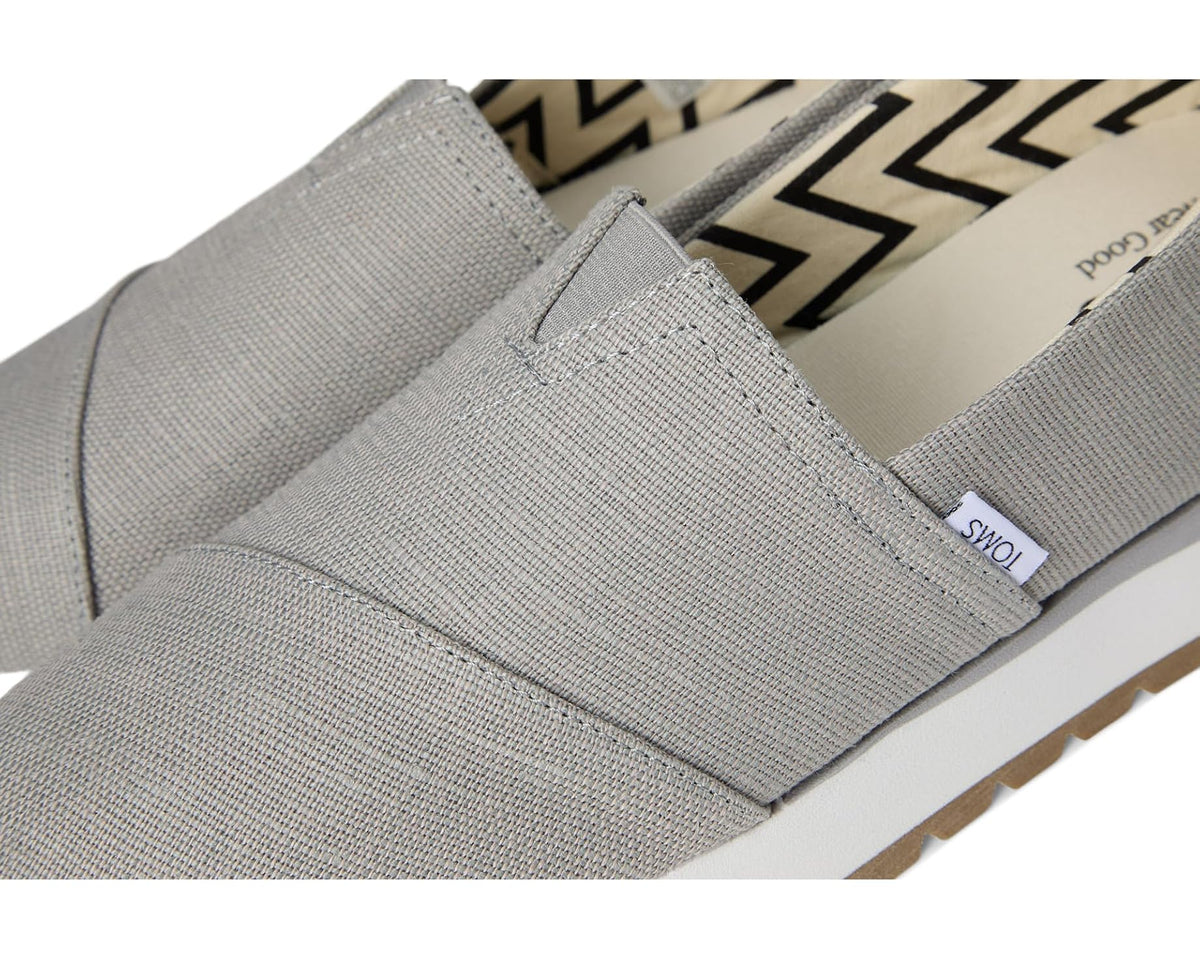 Men's TOMS slip-on shoe detail, grey fabric upper with elastic gore seam.
