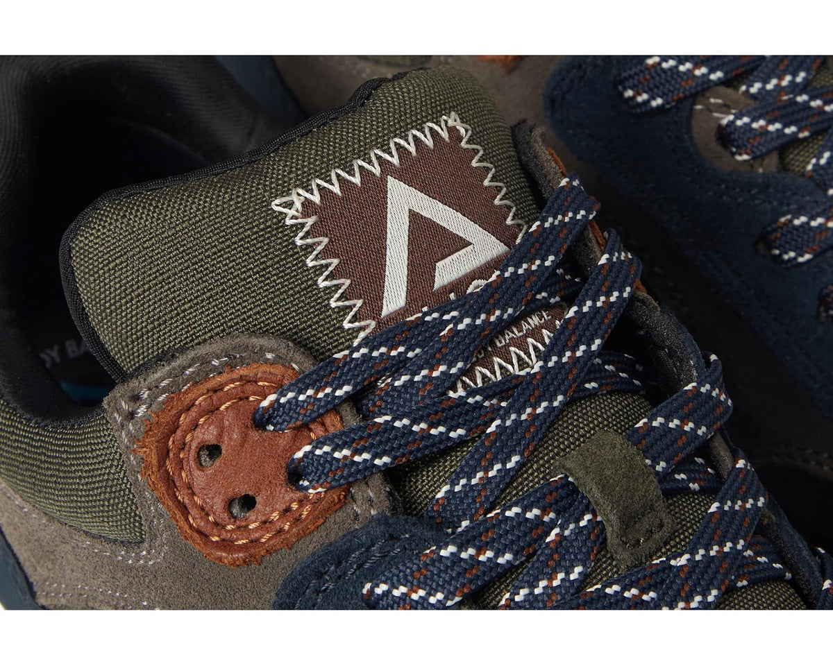 Men's trail sneaker close-up of patterned laces and logo patch