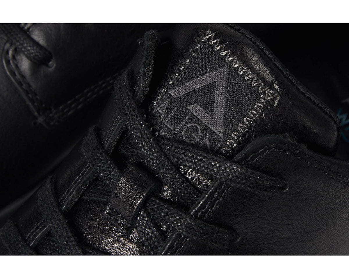Black lace-up sneaker with logo patch on tongue and textured upper