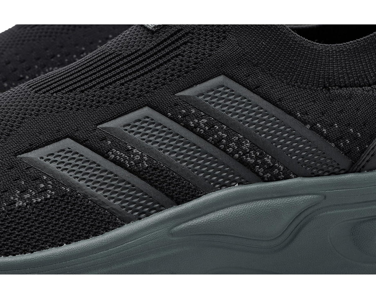 Close-up of black knit upper with grey stripe vents and teal cushioned midsole