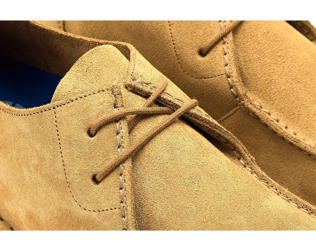 Close-up of men's cork brown suede lace-up shoe with laces and detailed stitching