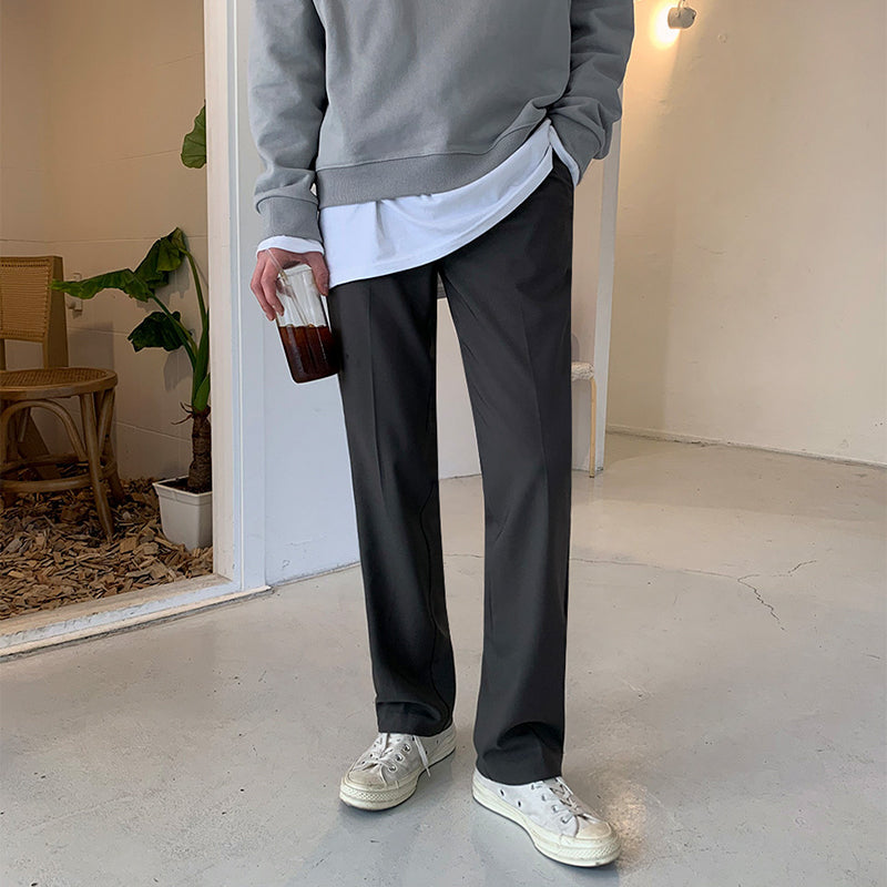 Loose straight trousers, dark gray with relaxed drape and side pockets