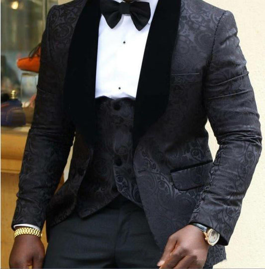 Black tuxedo suit with bow tie, white dress shirt, and patterned waistcoat vest