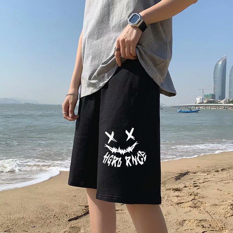 Black straight sports shorts with white X-eye monster graphic and bold text underneath.