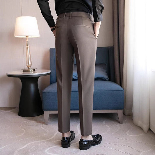 Men's dark gray dress pants with belt loops, flat front, and tapered legs