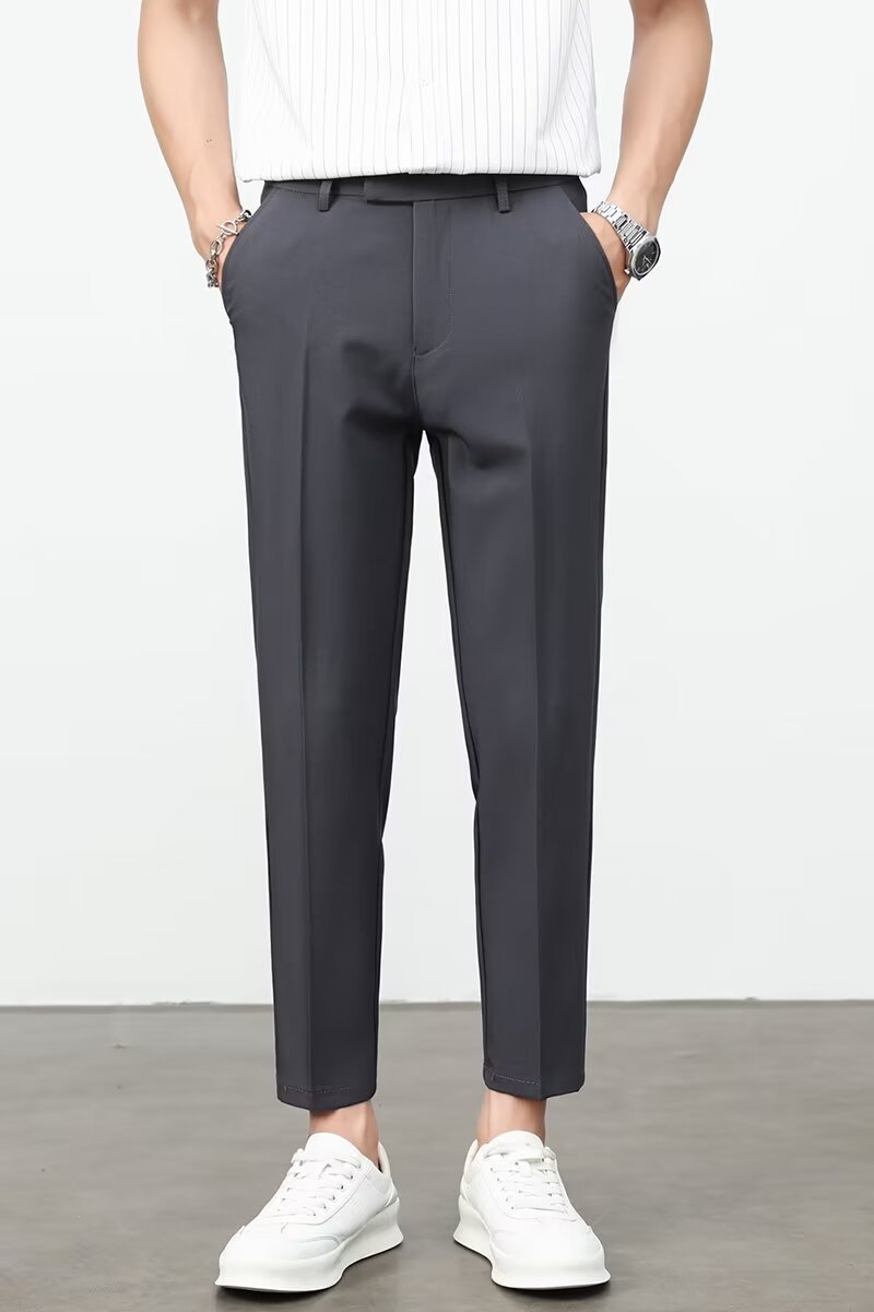 Men's dark gray dress pants with belt loops, flat front, and tapered ankle length
